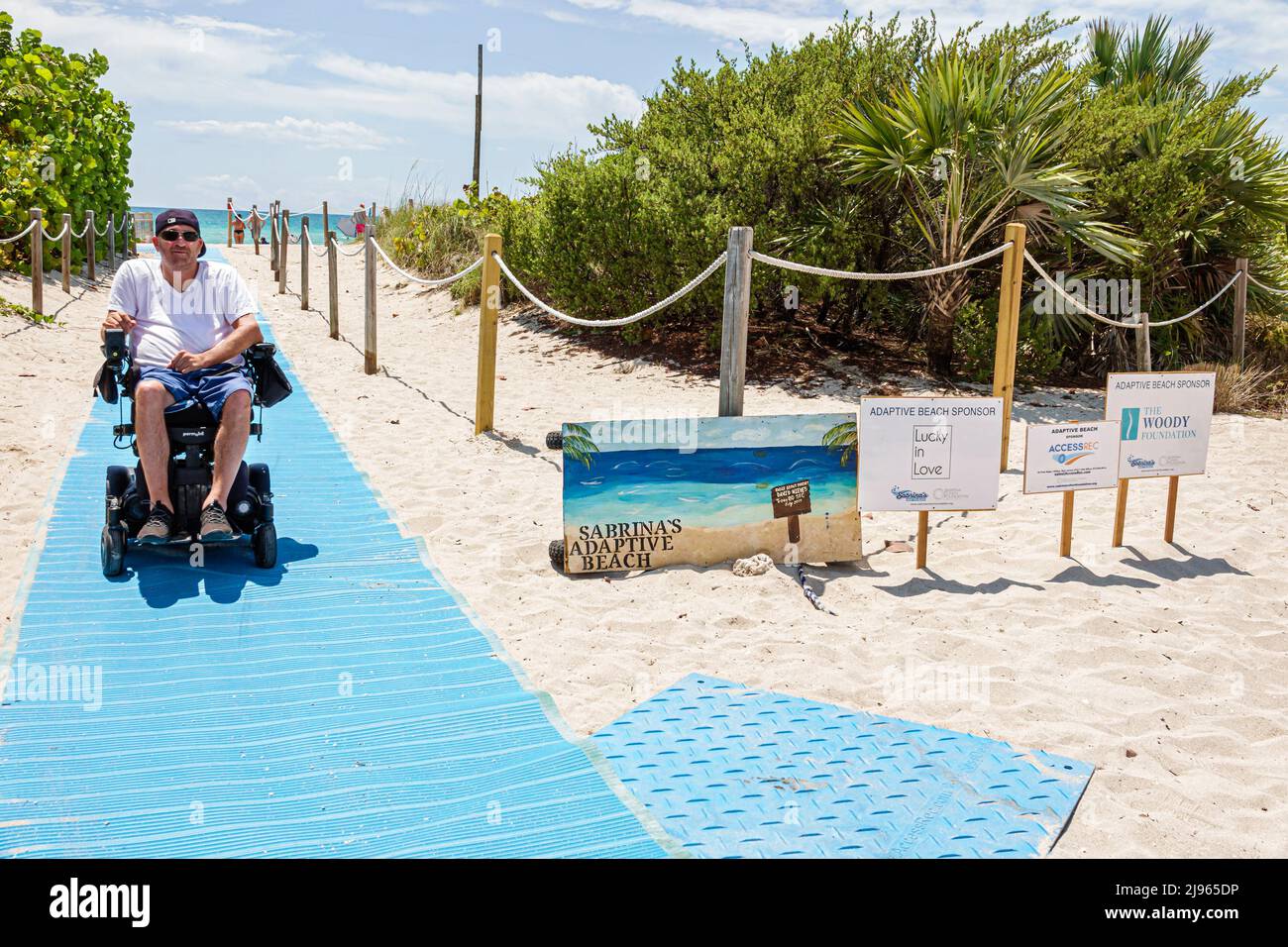 Miami Beach Florida,Sabrina Cohen Adaptive Beach Day,disabled special needs handicapped WaterWheels floating wheelchair,mat ramp entrance signs sponso Stock Photo