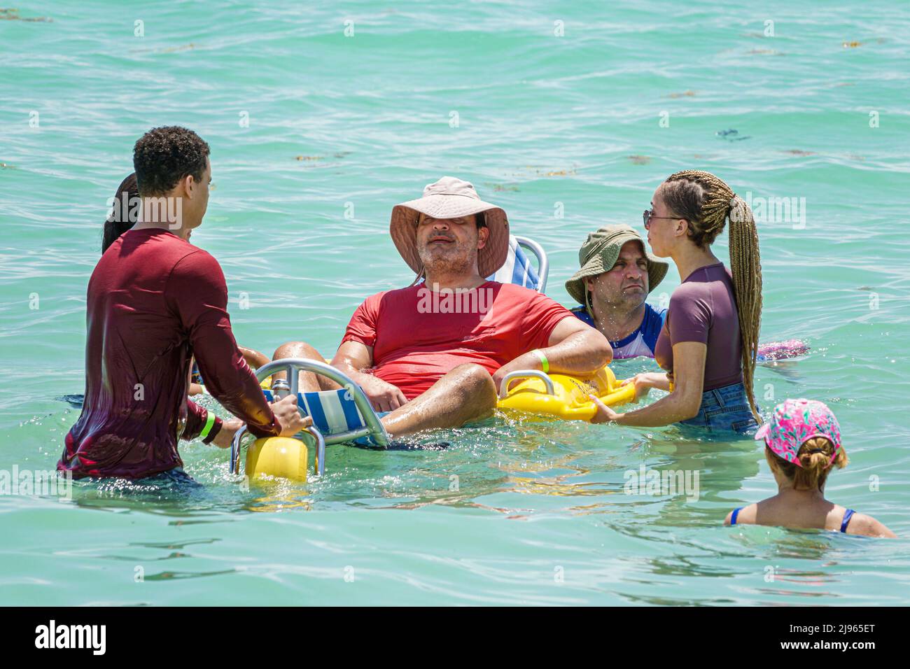 Miami Beach Florida,Sabrina Cohen Adaptive Beach Day,disabled special needs handicapped WaterWheels floating wheelchair,man male female woman voluntee Stock Photo