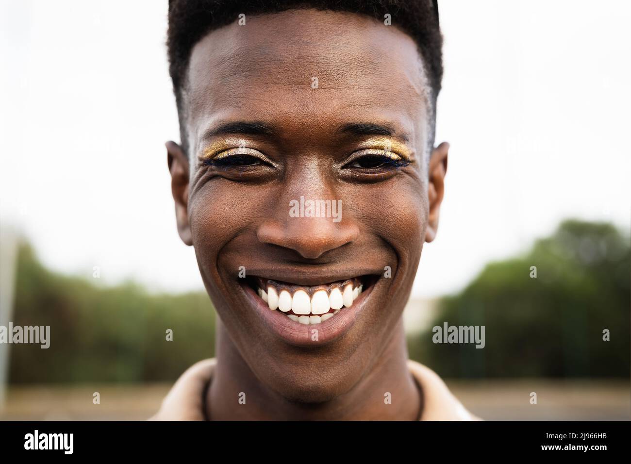 Happy African gay man smiling in front of camera Stock Photo