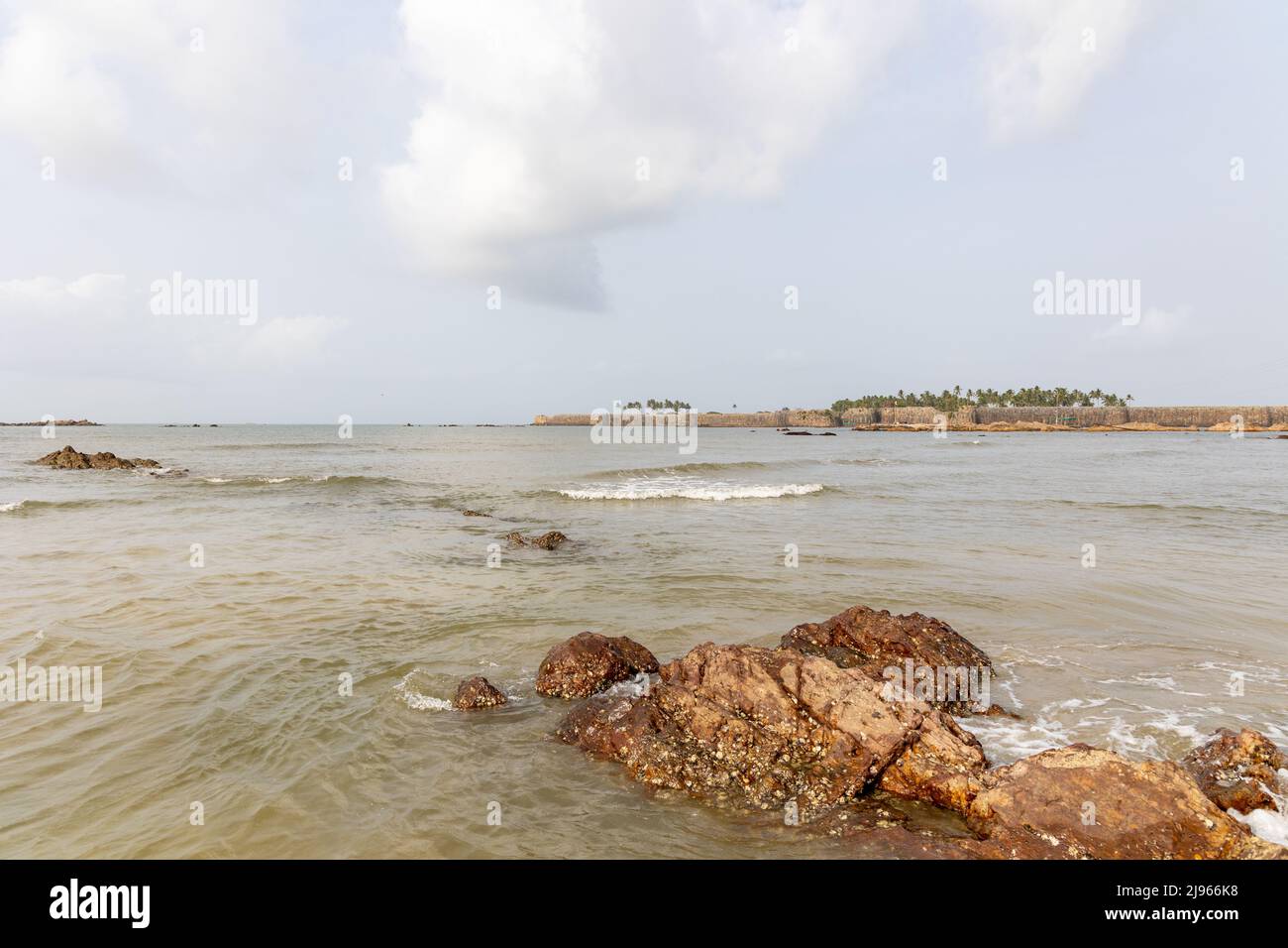 Creative composition showing Sindhudurg Fort with rocks in foreground as seen from Wayari Bhutnath Beach, Malvan, Maharashtra, India Stock Photo