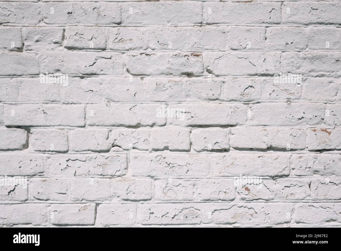 Grunge white brick wall background with aging texture closeup Stock Photo