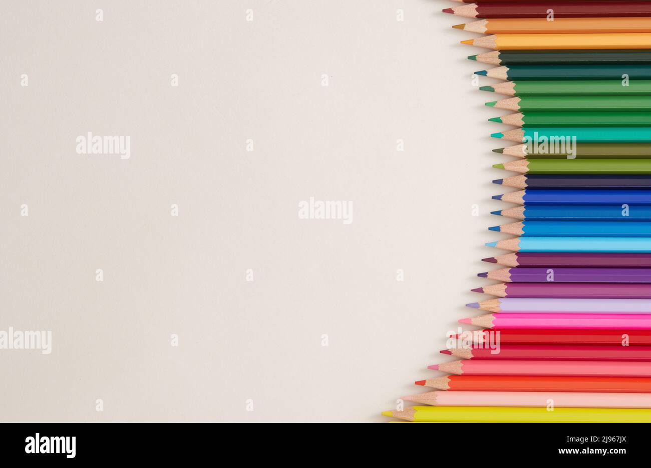Seamless horizontal pattern Colored pencils arranged in a wave with copy space for note, text, on white background. Stock Photo