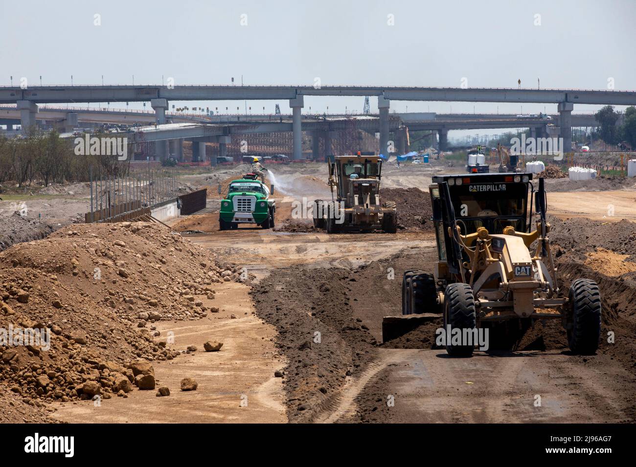 A motor grader prepares the ground for the Suburban Train railway that will connect Felipe Angeles Airport with Mexico City Stock Photo