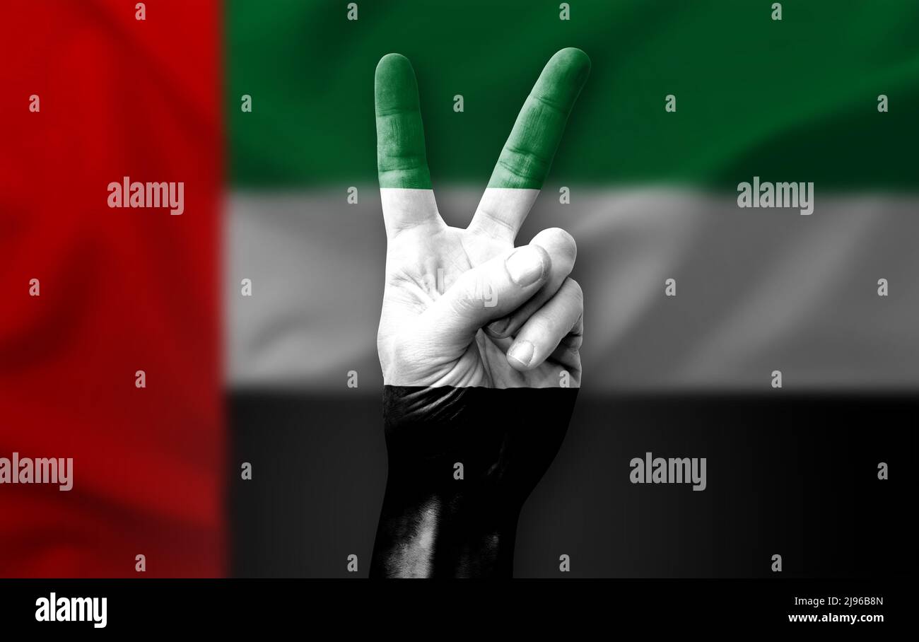 Hand making the V victory sign with flag of uae Stock Photo - Alamy