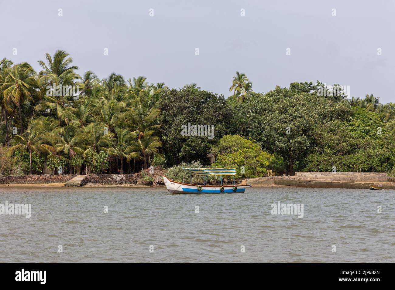 View of a boat anchored amidst the scenic Karli Riverbank during the boat ride on Karli River. Stock Photo