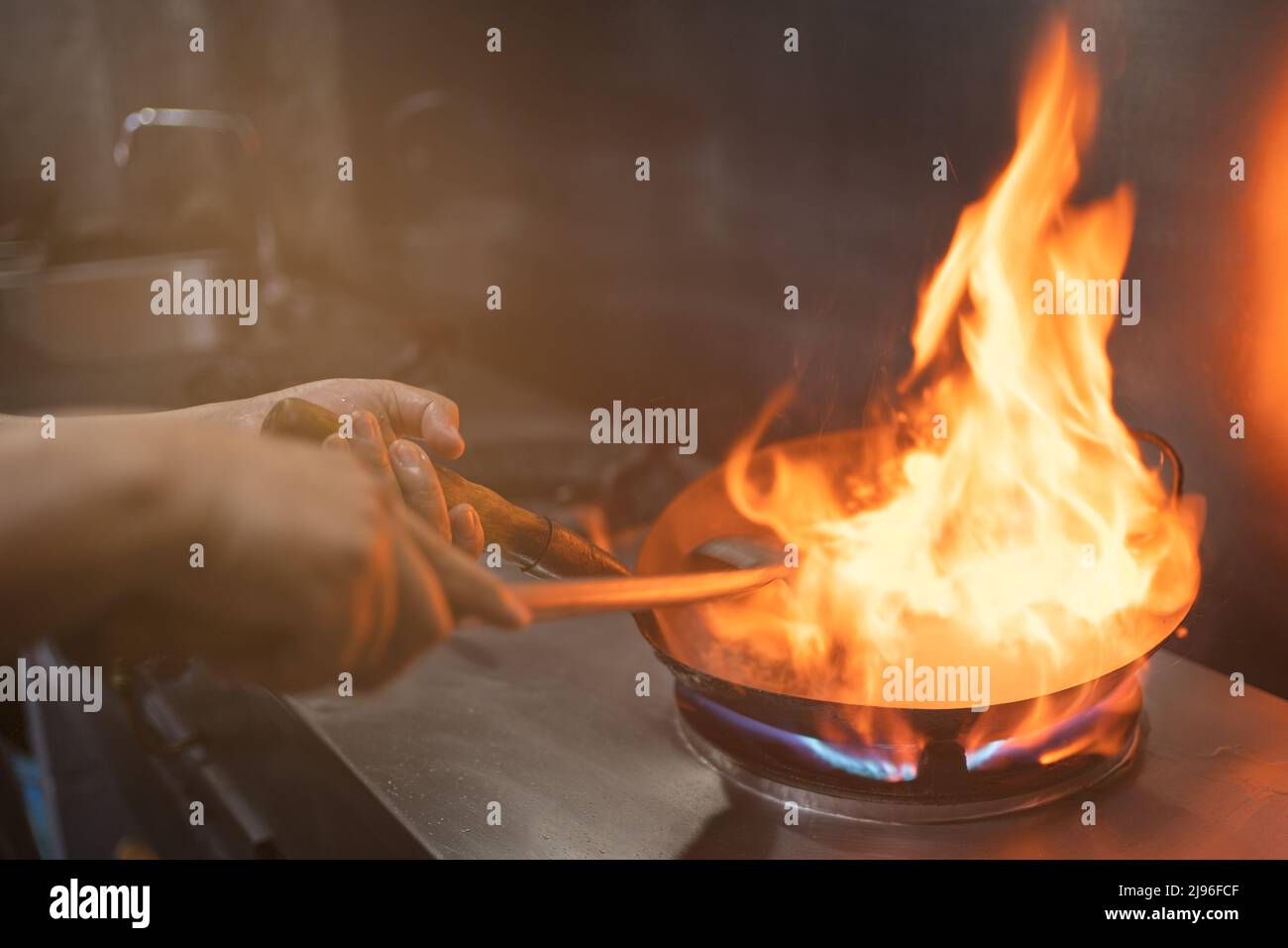 Chef stir fry in wok. Dramatic cooking with fire hard Stock Photo Alamy