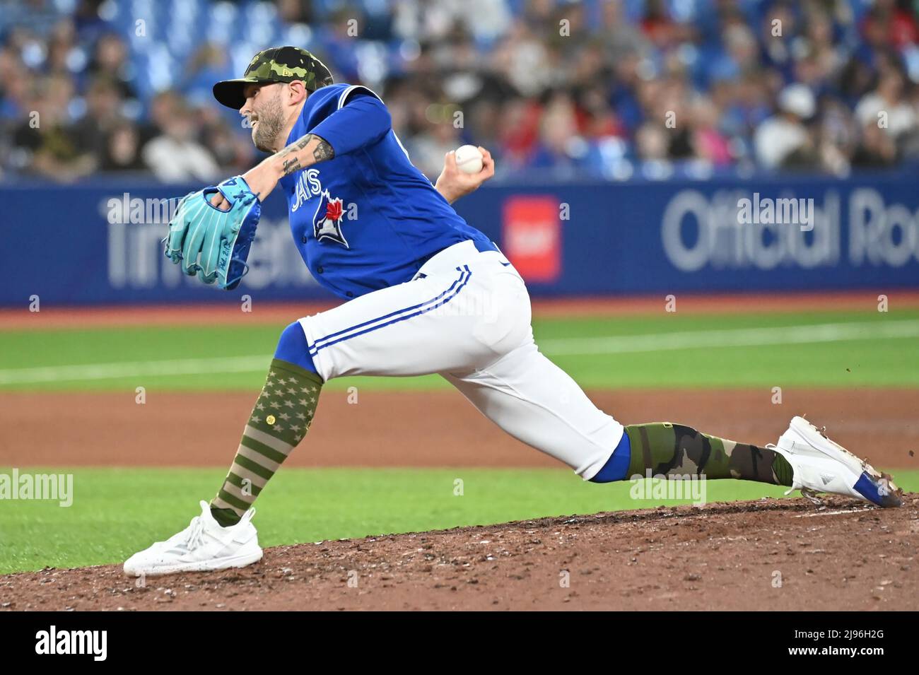 Toronto Blue Jays' Adam Cimber follows through on his delivery to
