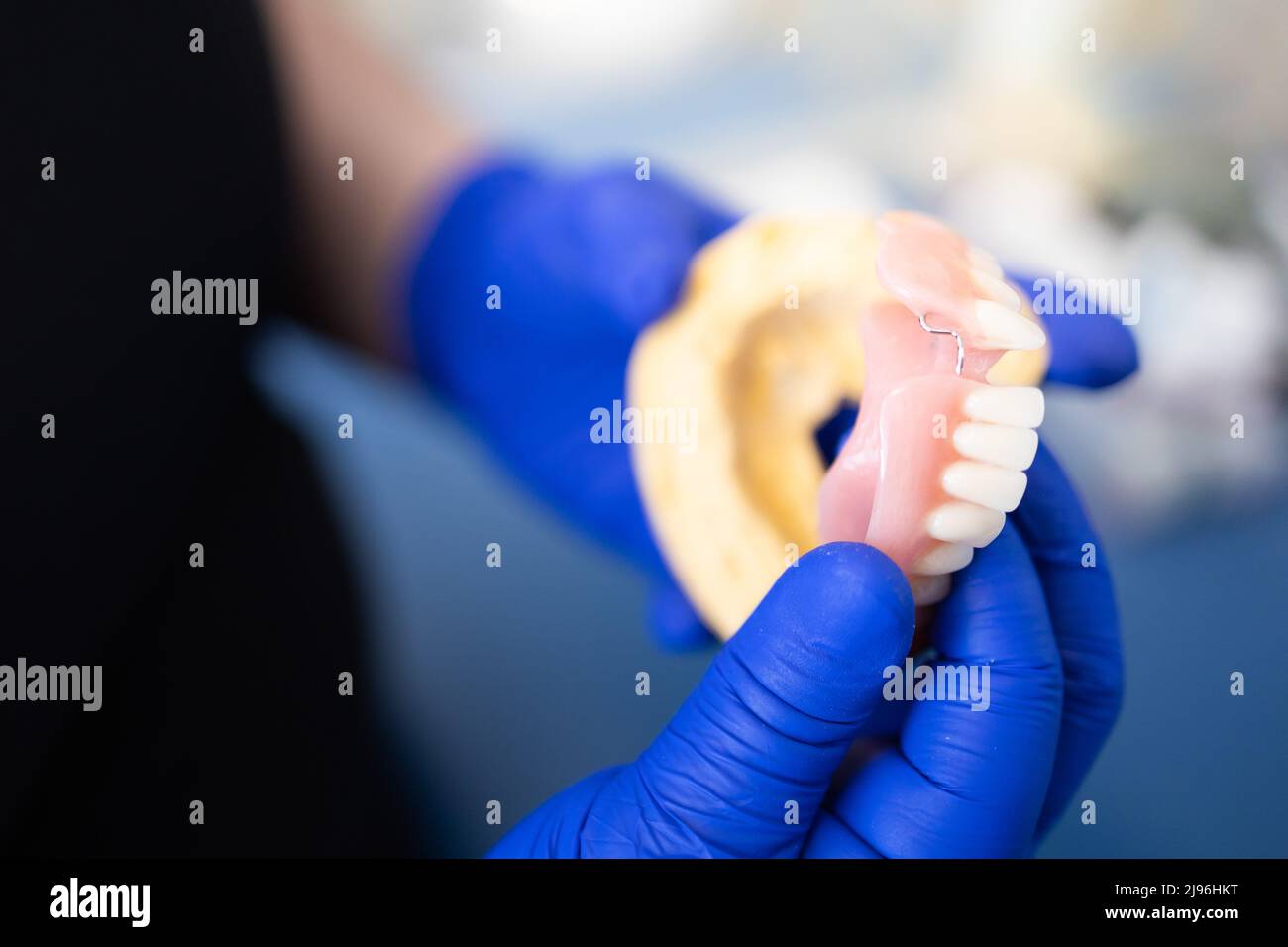 Dentist holding an artificial lower jaw. Dental Prosthesis. Zirconium