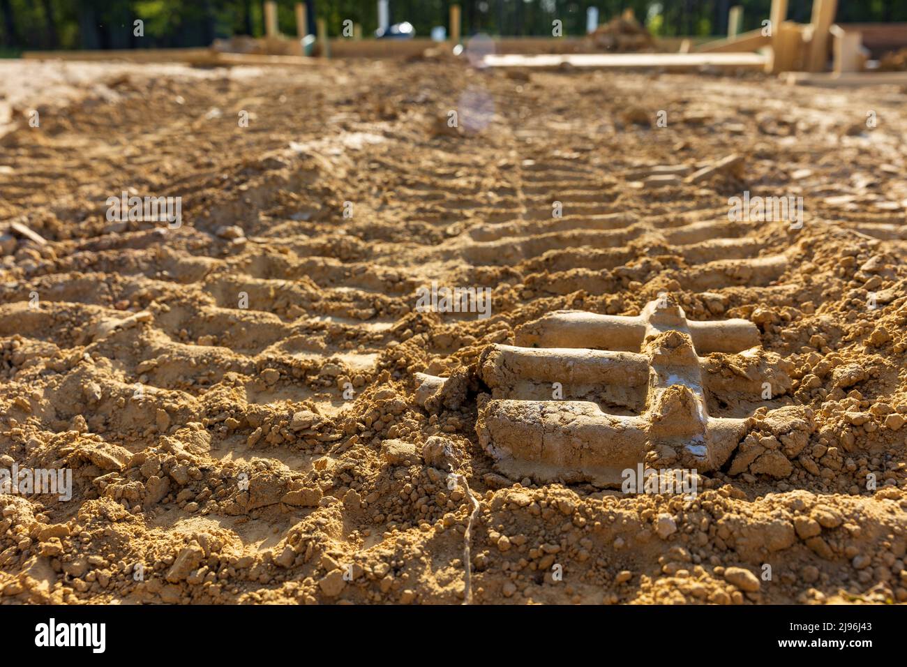 Bulldozer tracks in dirt on construction site Stock Photo