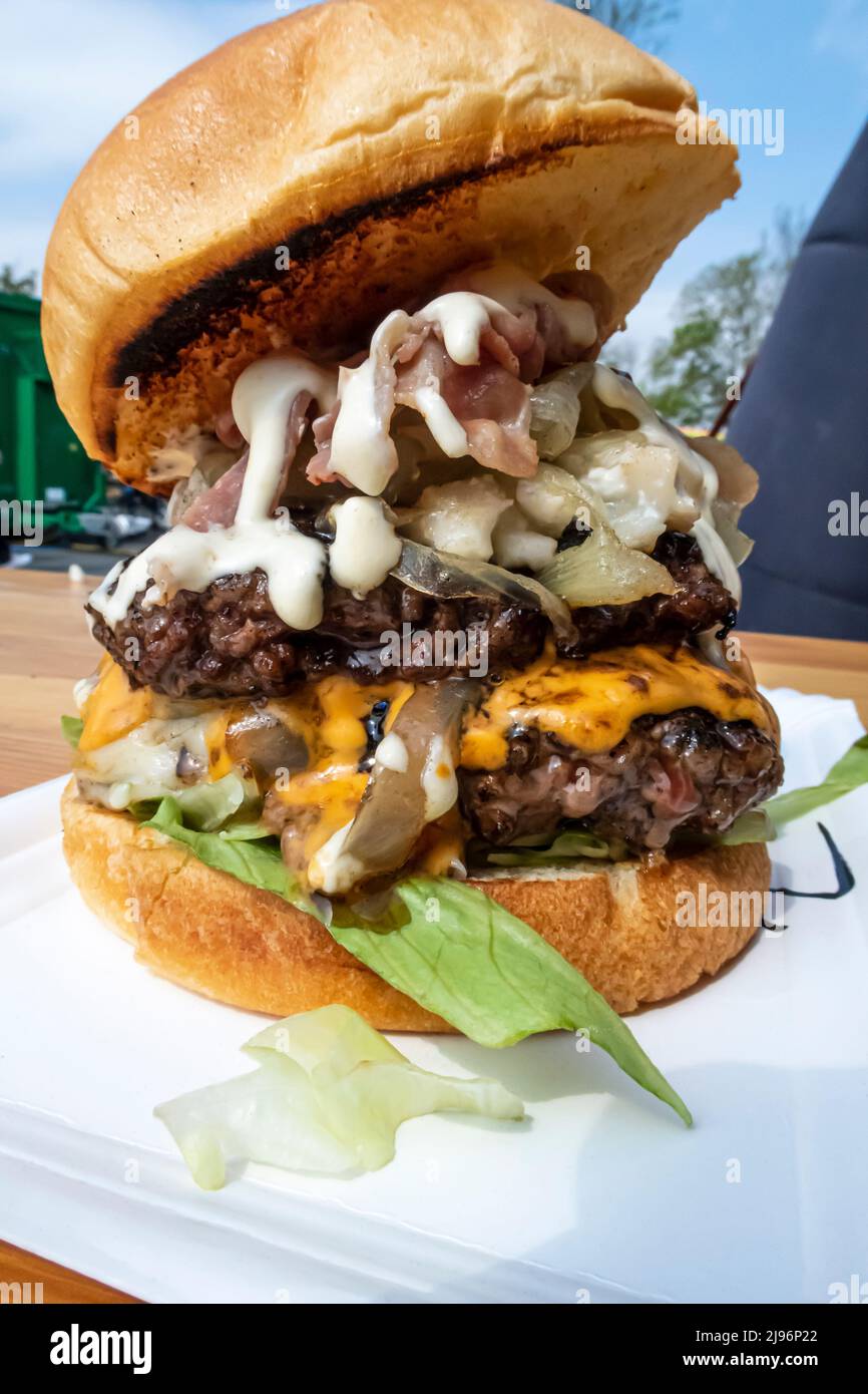 Close-up of a delicious burger with two meats, bacon, sauces and fried onions Stock Photo