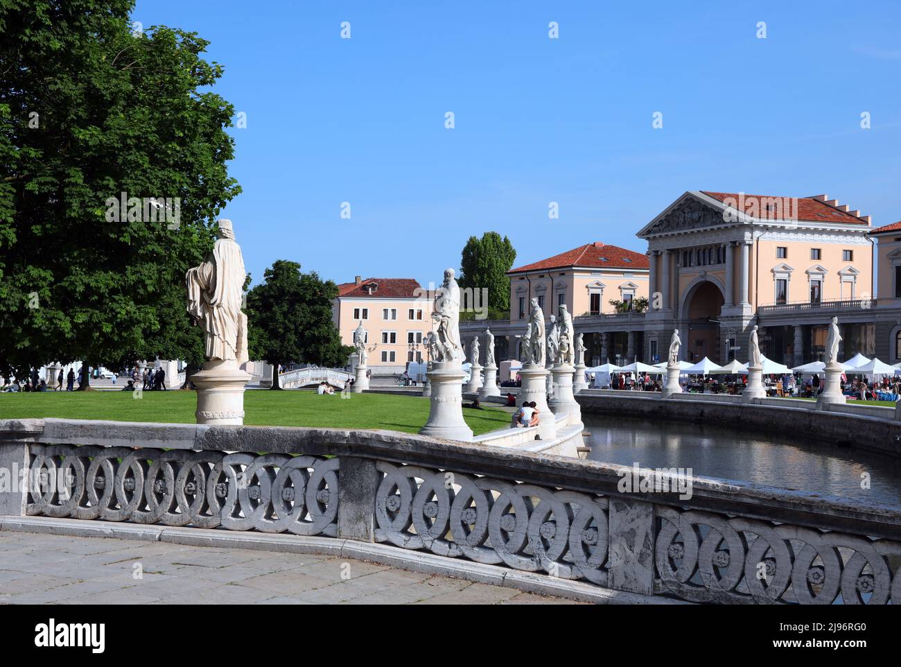 Prato della Valle in Padua City in ITALY in Veneto REGION is a wide public square with many statues of famous historical figures and a small water can Stock Photo