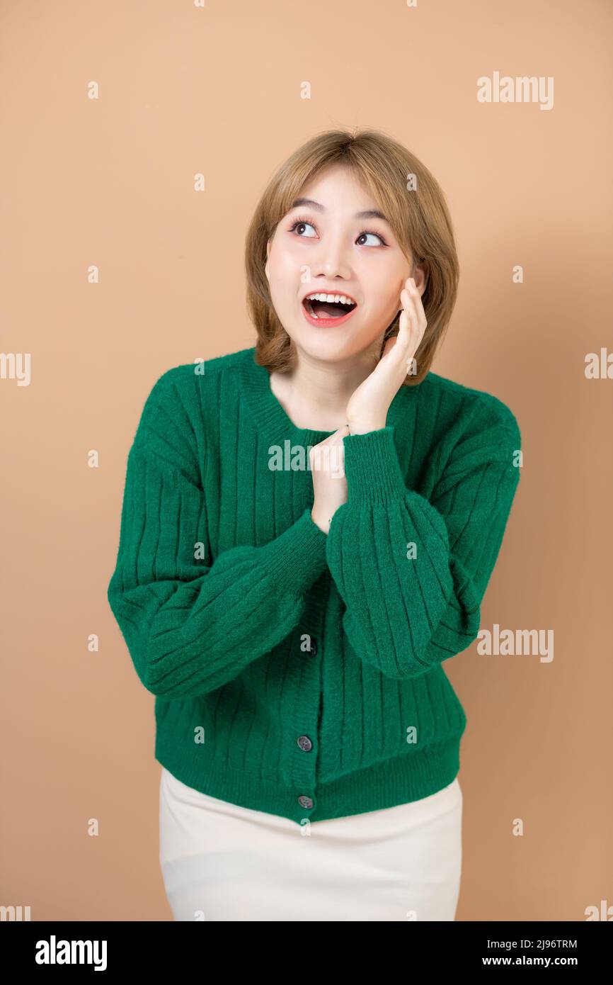 Amazed Asian Woman emotionally reacting to nice offer or promo Stock Photo