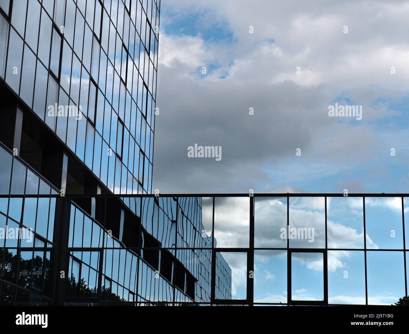 Blue Sky and Clouds Reflected in the Glass Building Stock Photo - Alamy