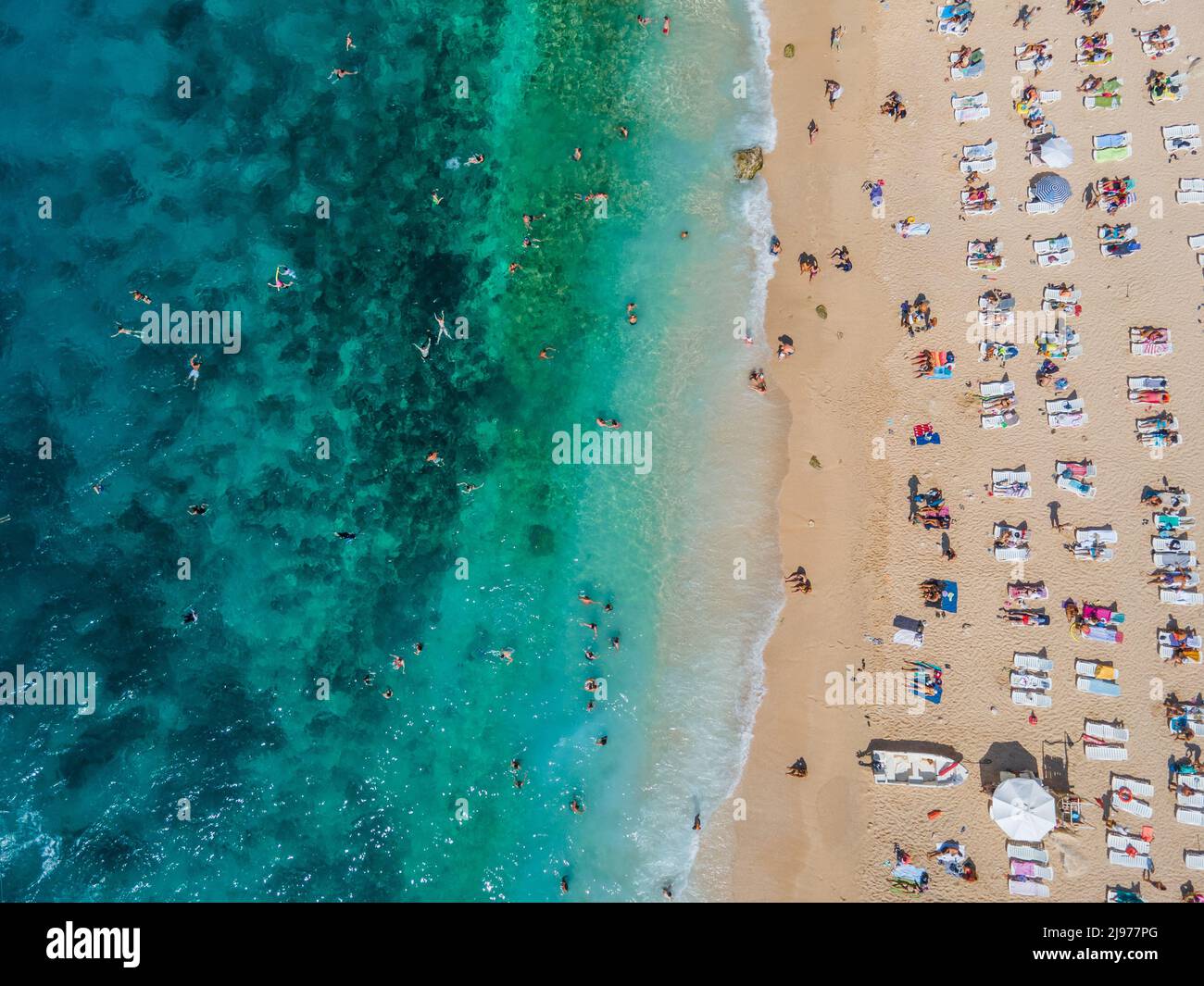 Drone footage of people sunbathing on Kaputaş beach - Kalkan, Antalya Stock Photo