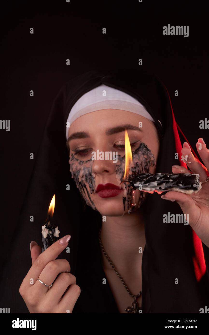 Vertical shot portrait of a young girl with face stained in candle wax
