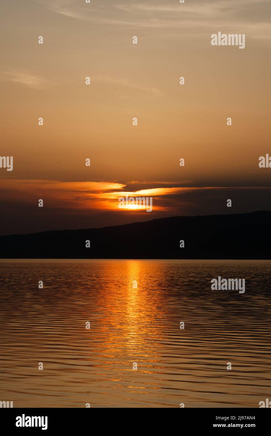 Setting Sun Reflection Sun setting close to the sea creating a reflection on water Stock Photo ...