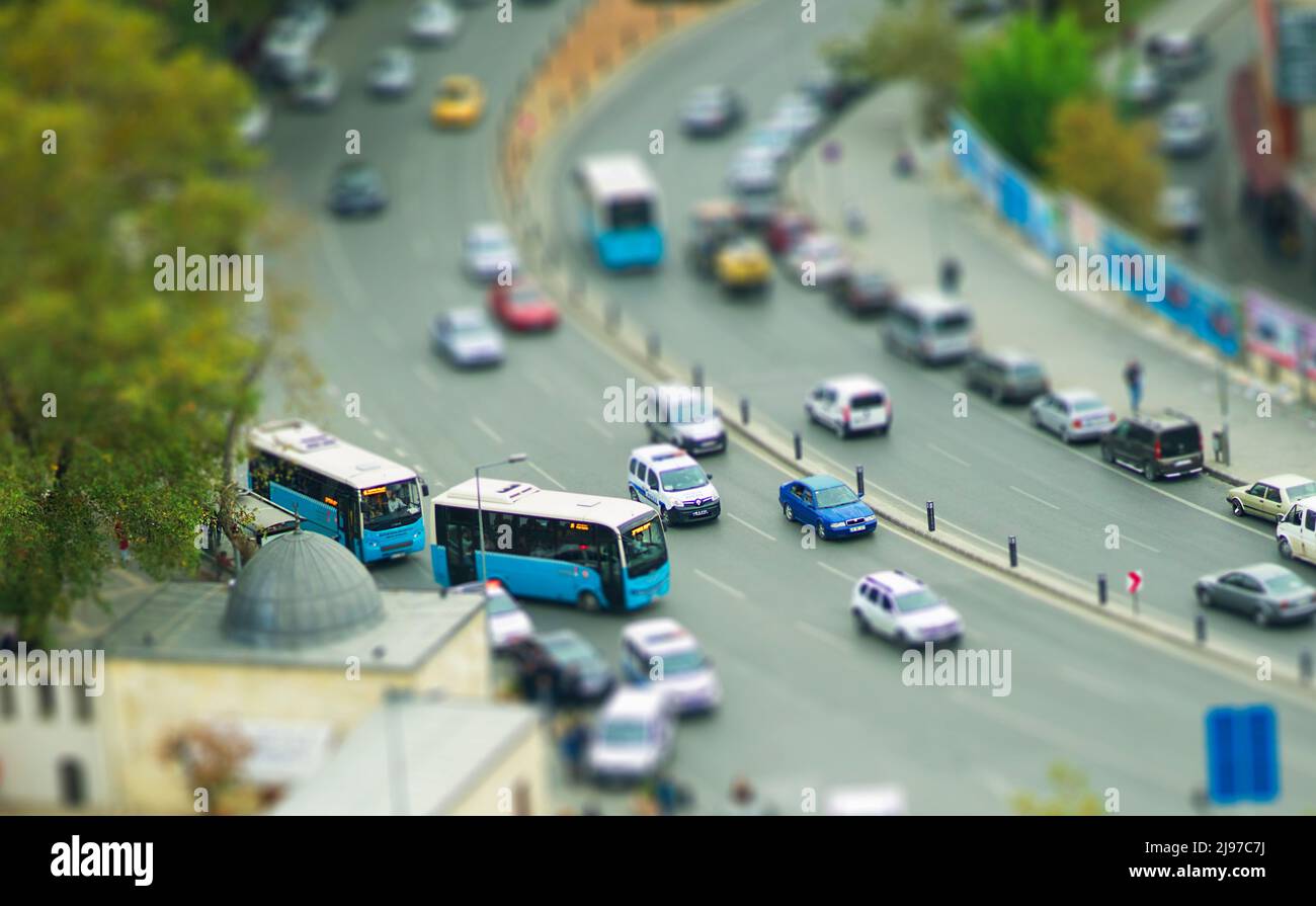 tilt shift effect aerial photography of traffic and road with busses, cars. Stock Photo