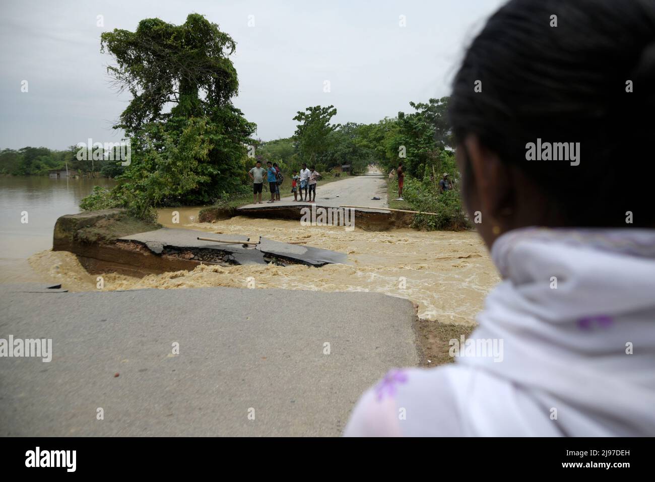 Assam, India. 20th May, 2022. Villagers standing near a damaged road after flooding flowing heavy rainfall, in Nagaon, Assam, India on 20 May 2022. At least 10 people have died in floods and landslides due to pre monsoon rain in Assam. Credit: David Talukdar/Alamy Live News Credit: David Talukdar/Alamy Live News Stock Photo