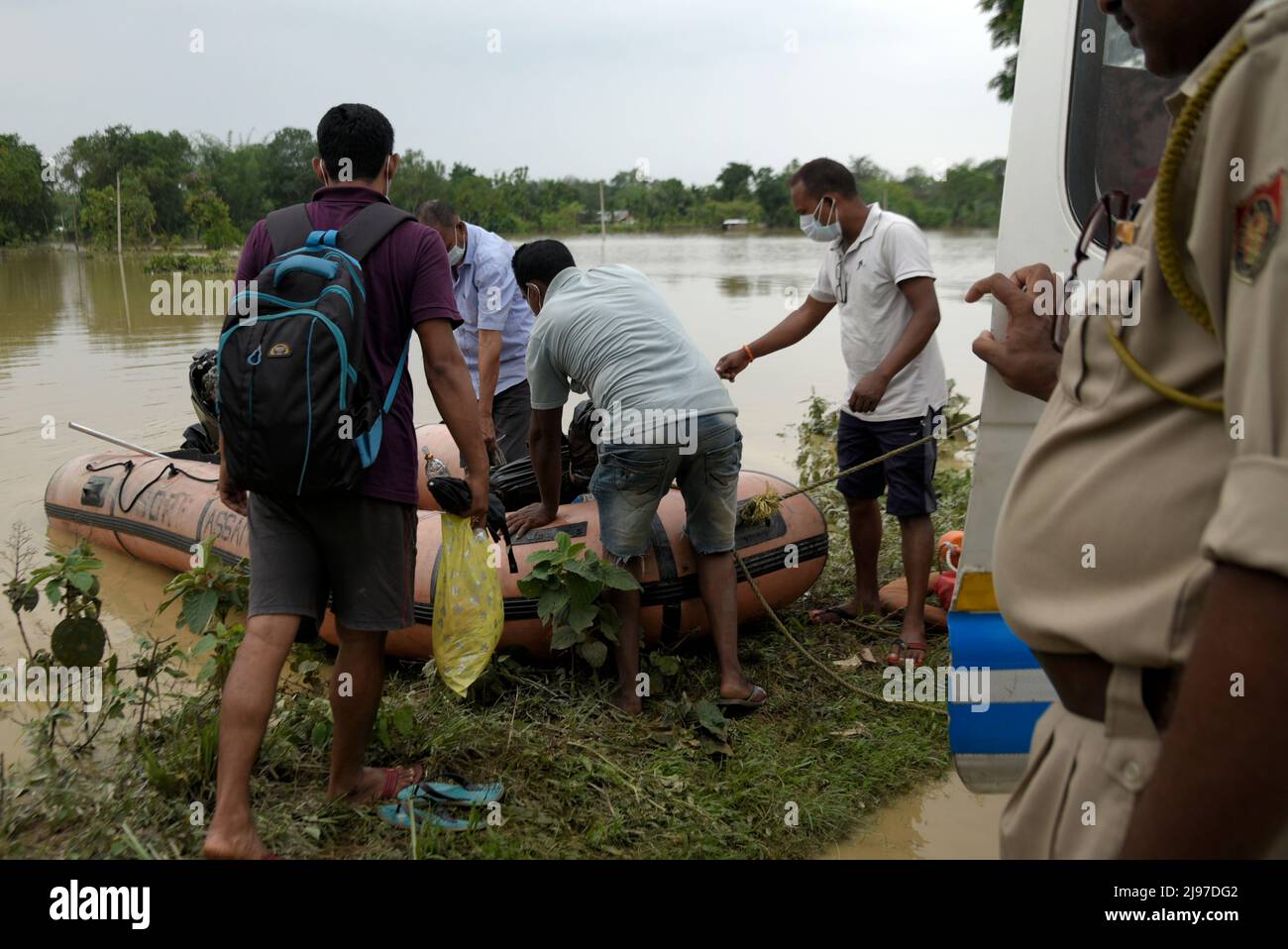 Assam, India. 20th May, 2022. NDRF jawan loading the dead body of Binanda Nath (13), in an ambulance, who was dead in flood water after flooding flowing heavy rainfall, in Nagaon, Assam, India on 20 May 2022. At least 10 people have died in floods and landslides due to pre monsoon rain in Assam. Credit: David Talukdar/Alamy Live News Credit: David Talukdar/Alamy Live News Stock Photo