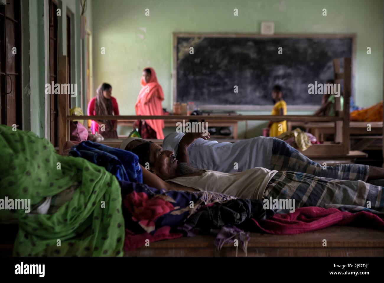 Assam, India. 20th May, 2022. Villagers affected by a flood take shelter at a school, after flooding flowing heavy rainfall, in Nagaon, Assam, India on 20 May 2022. At least 10 people have died in floods and landslides due to pre monsoon rain in Assam. Credit: David Talukdar/Alamy Live News Credit: David Talukdar/Alamy Live News Stock Photo