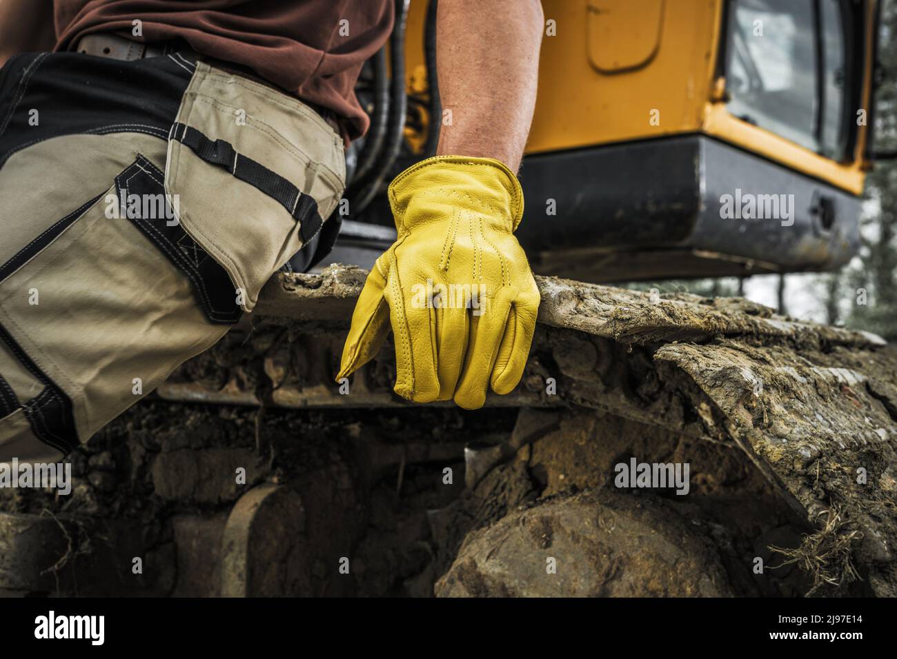 Bulldozer Operator Resting on a Caterpillar Track Close Up. Heavy Duty Machinery Ground Moving
