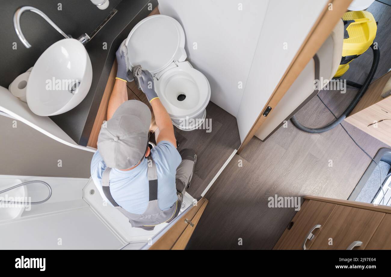 RV Recreastional Vehicle Rental Company Worker Keeping Motorhome Toilet