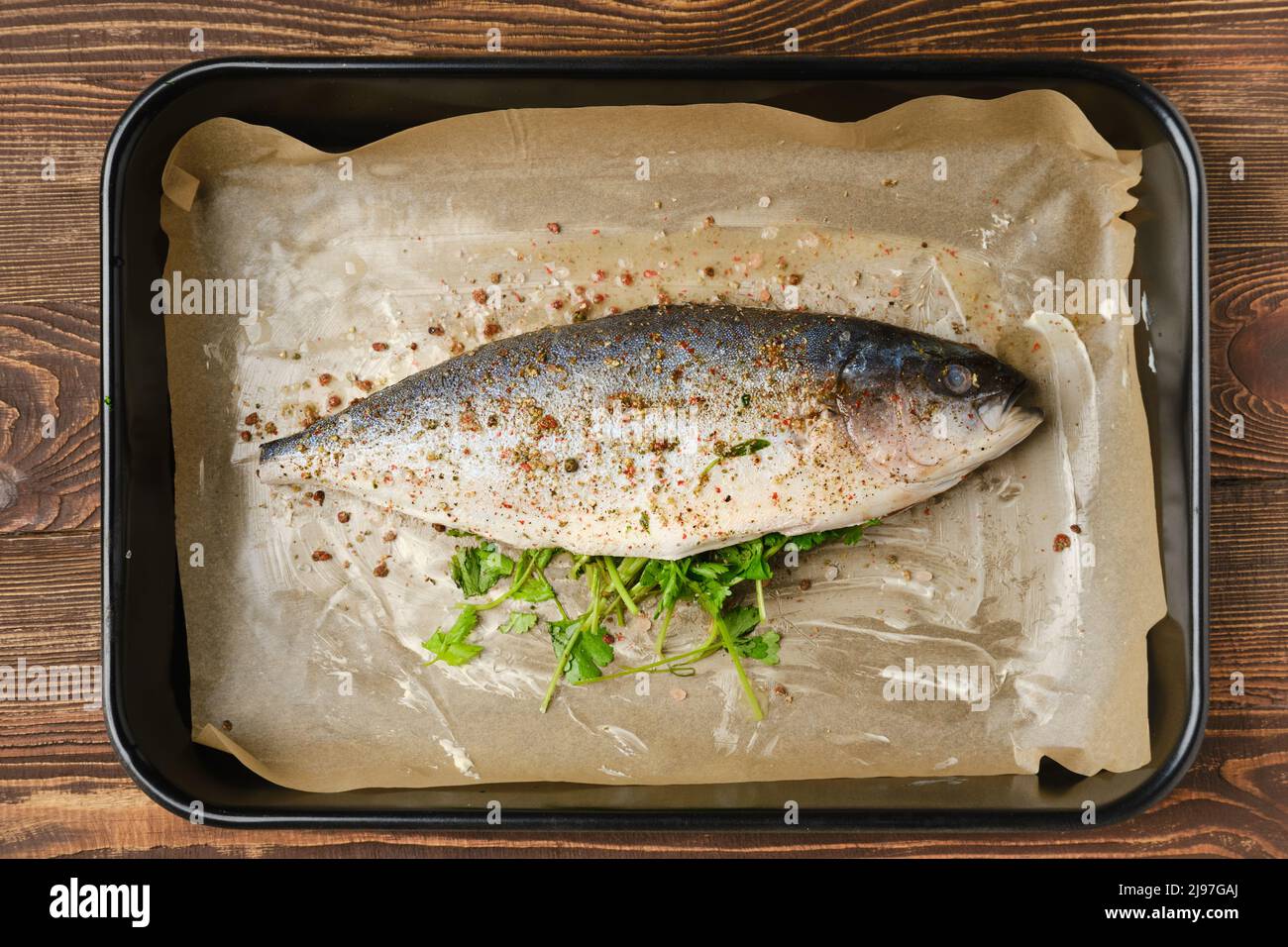 Fresh sea yellow tailed horse mackerel in baking tray, marinated and seasoned, top view Stock Photo