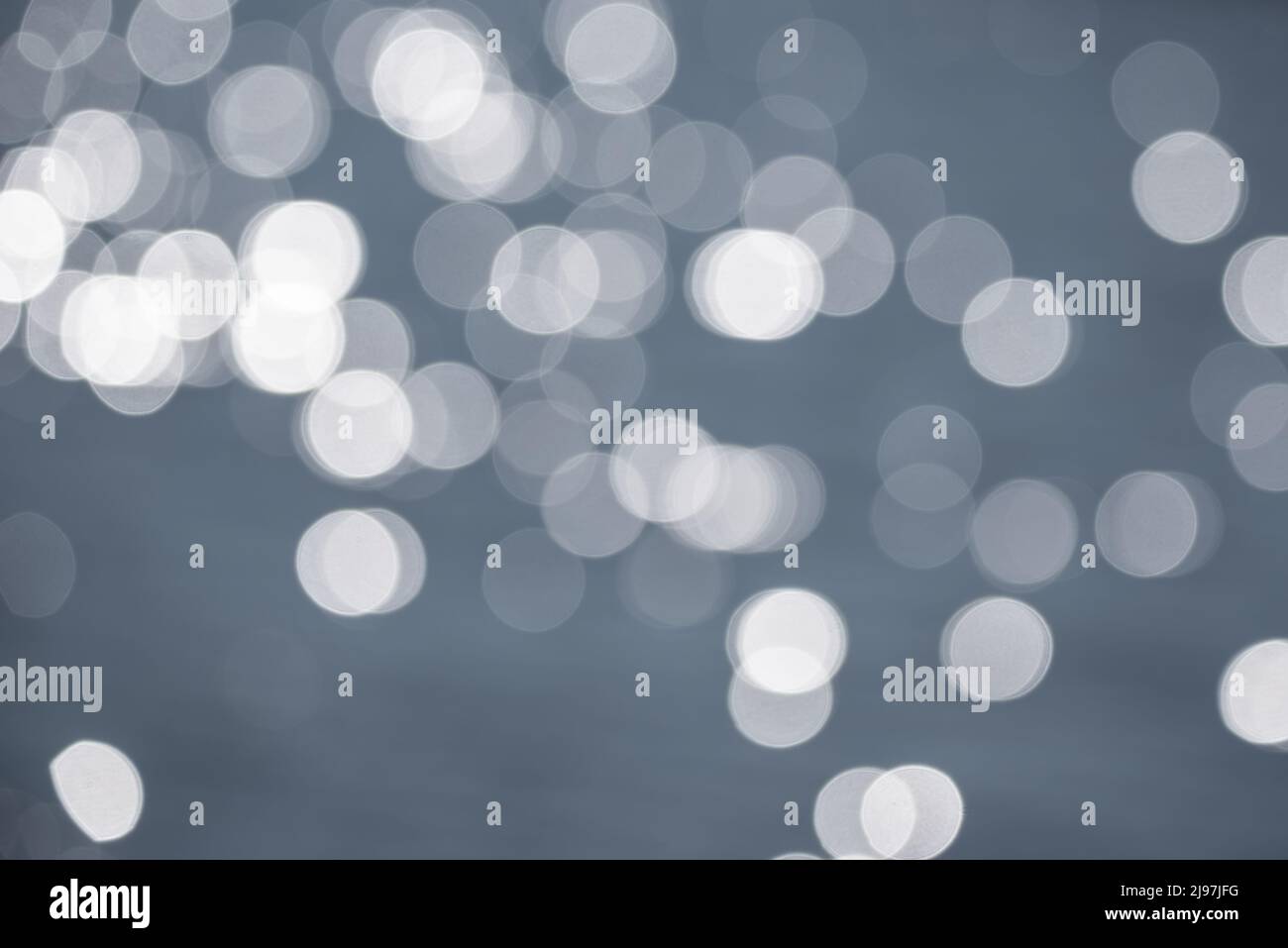 Beautiful blurred bokeh effect image of specular highlights on lake