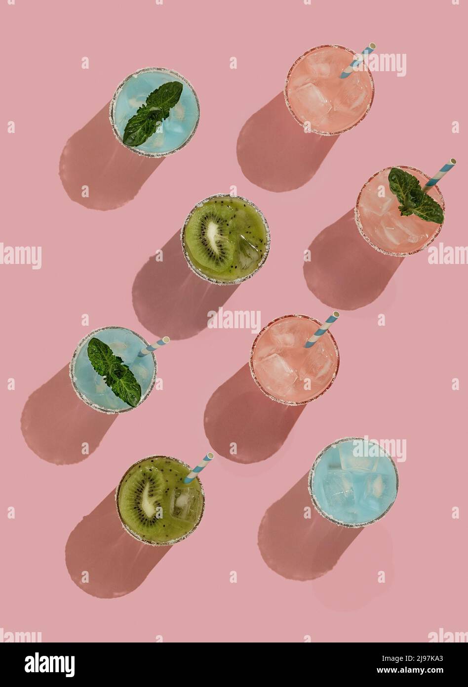 Summer pattern on bright pink pastel sunlight background delicious cocktails. Drinks with tropical fruits in glasses. Stock Photo