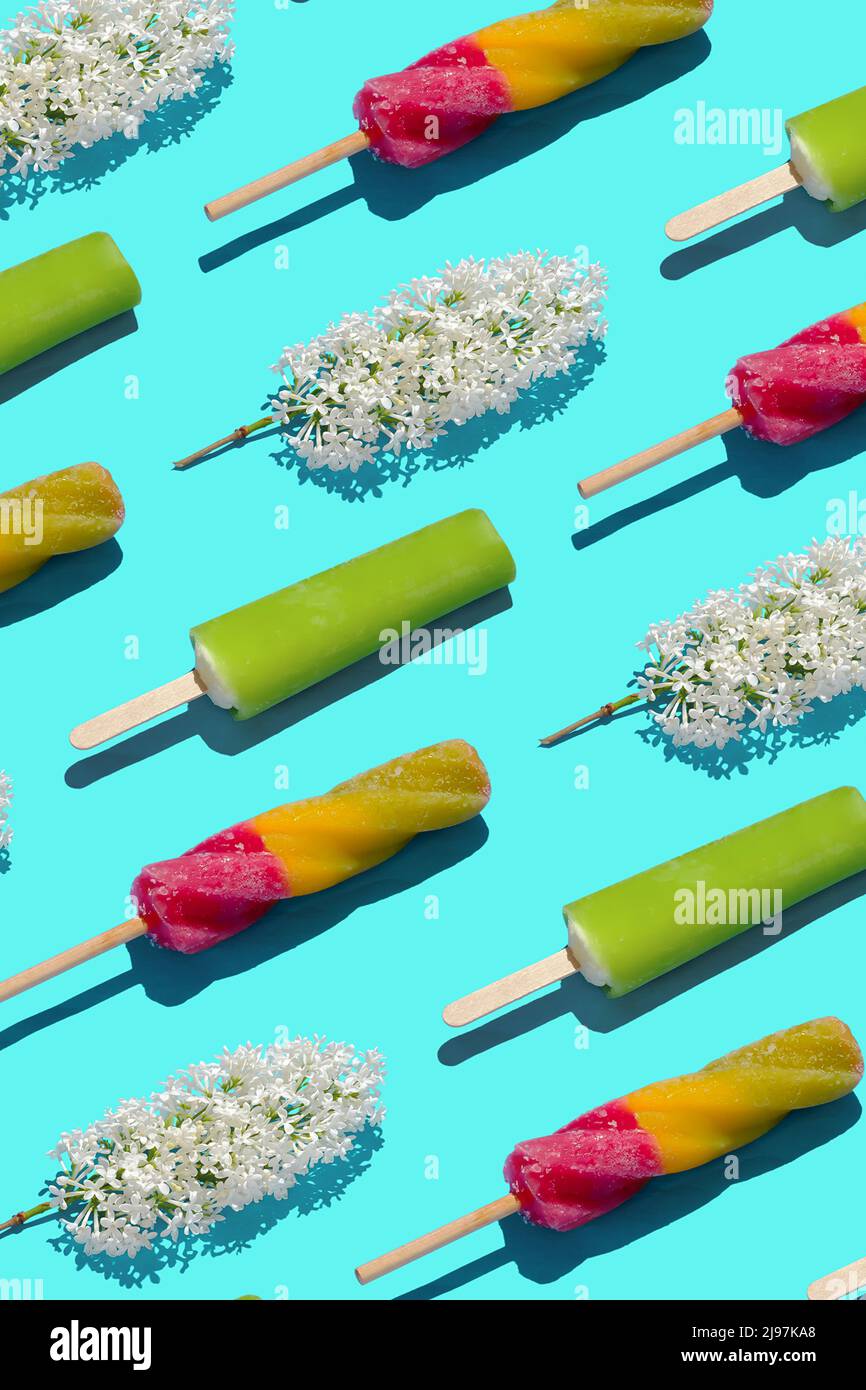 Bright pastel summer pattern ice cream and flowers in a flat lay style and top view. Minimal creative summer food and joy concept. Stock Photo