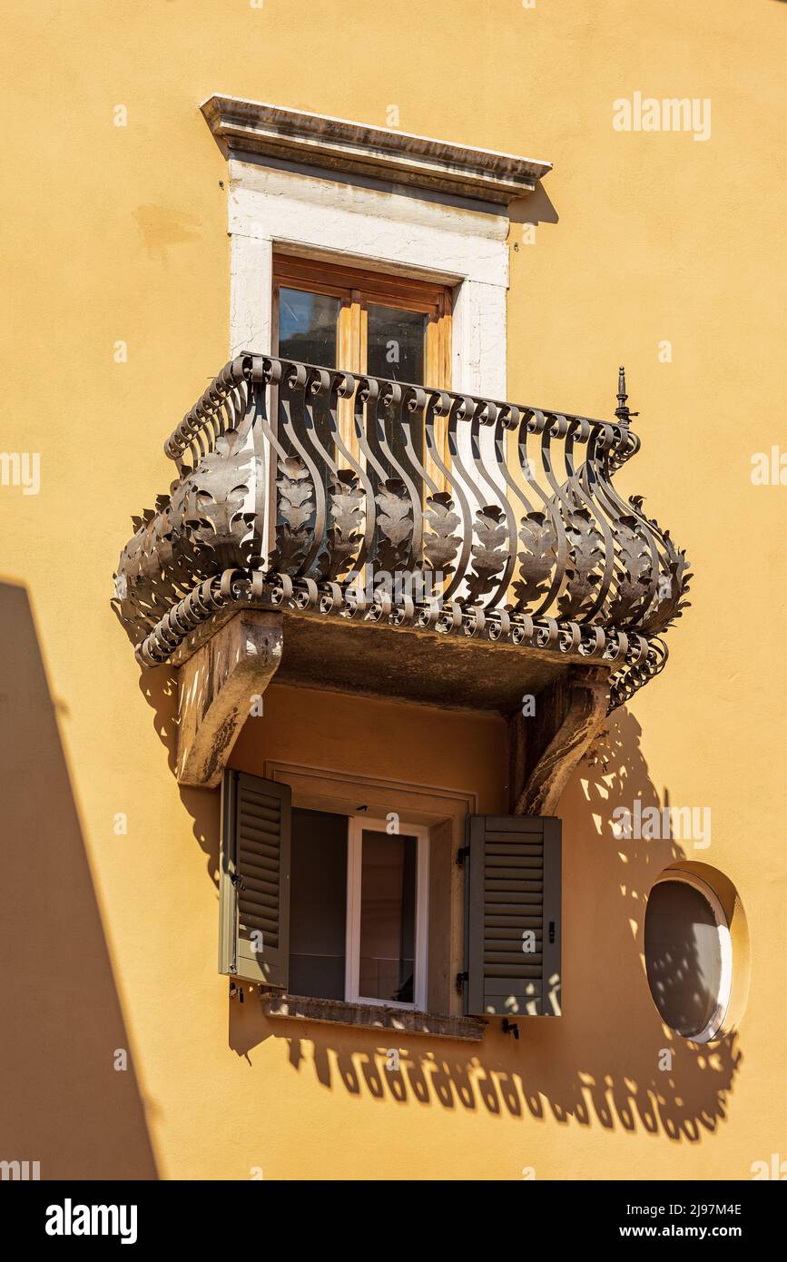 Close-up of a beautiful balcony with ancient wrought iron railing in Brescia downtown, Lombardy, Italy, Europe. Stock Photo
