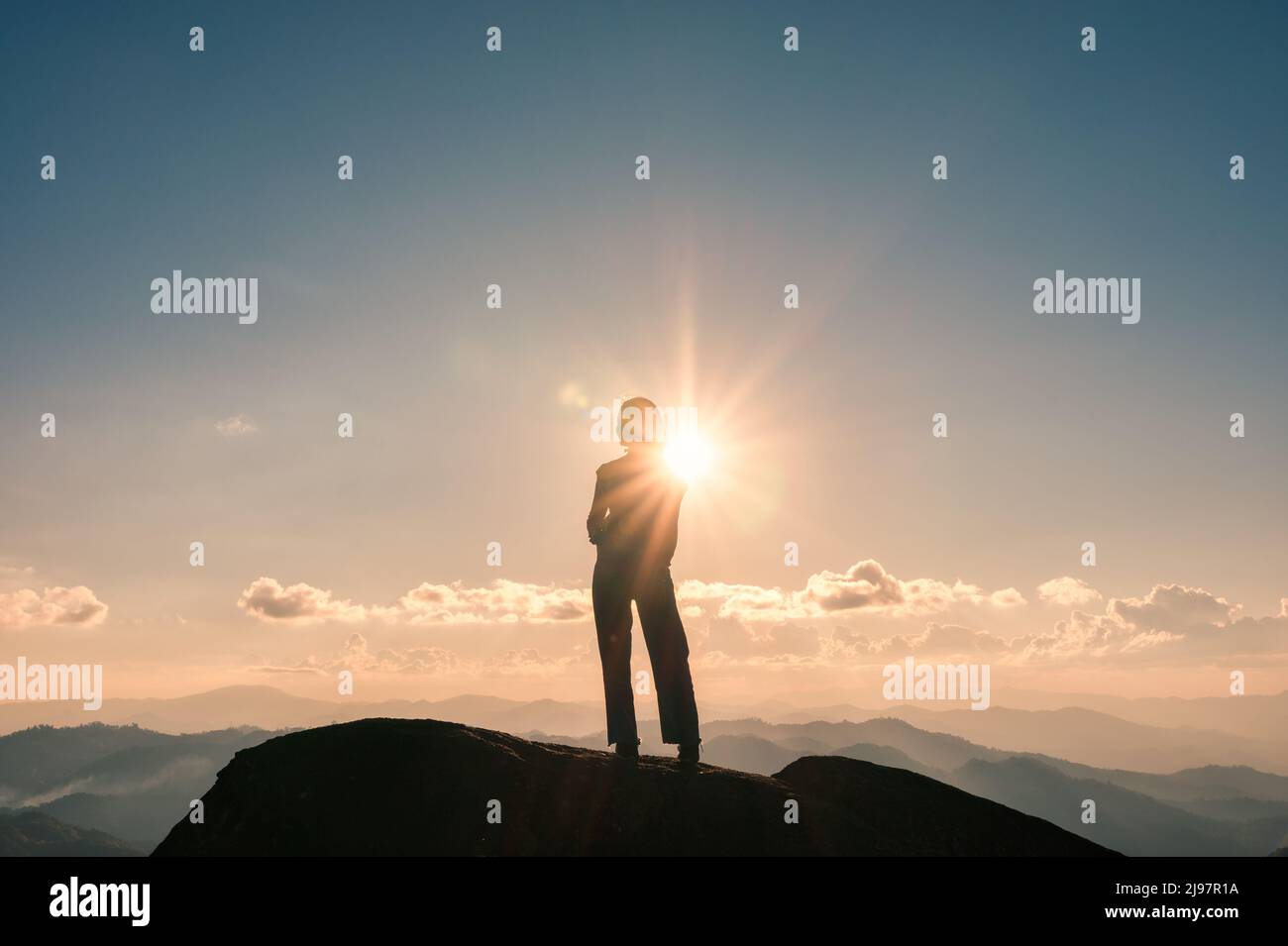 Successful silhouette young hiker woman standing on top of mountain ...