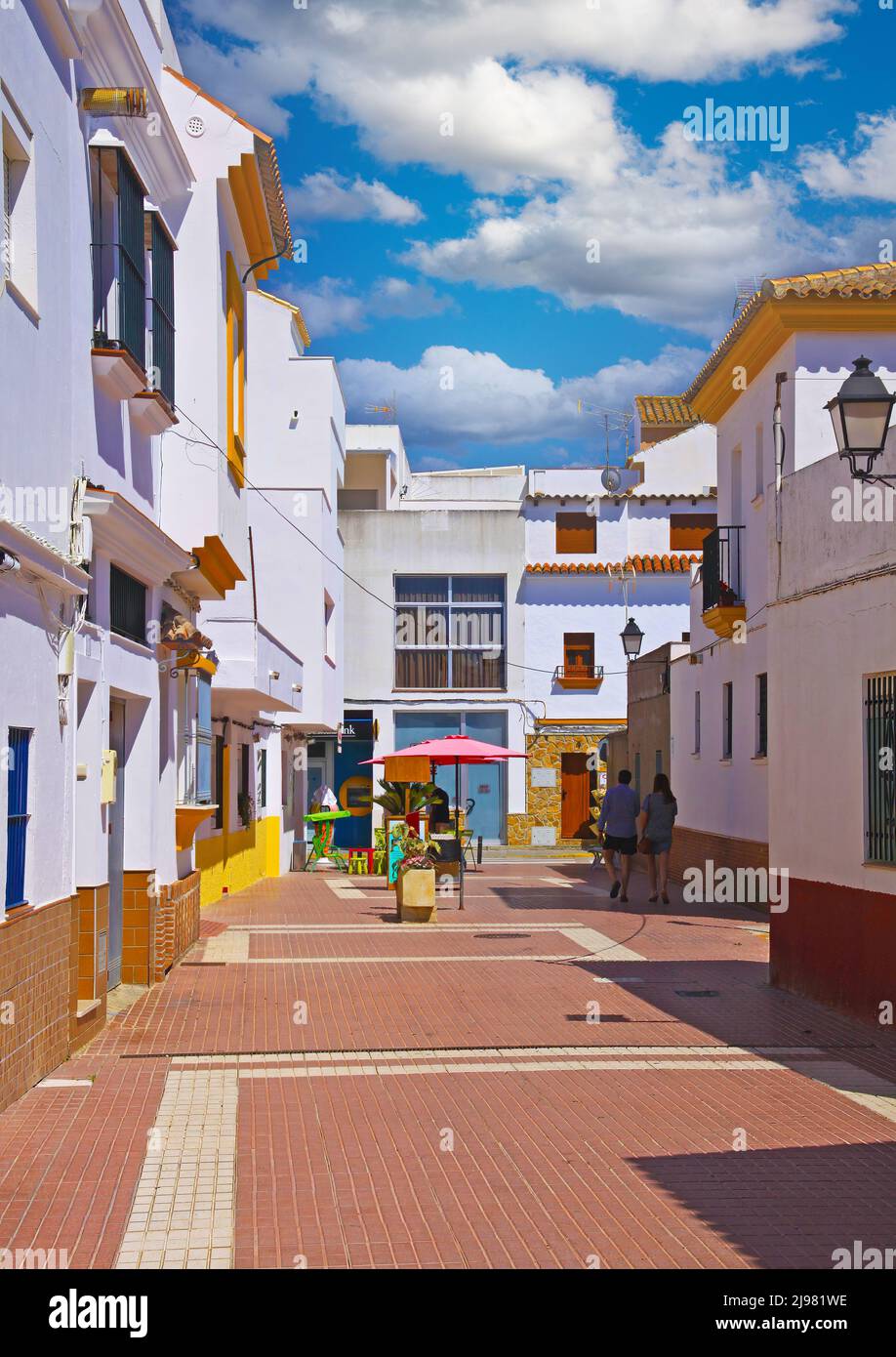 Zahara de los Atunes, Spain - June 1. 2019: Tranquil street scene in typical spanisch atlantic ocean village, empty siesta pedestrian road, white hous Stock Photo
