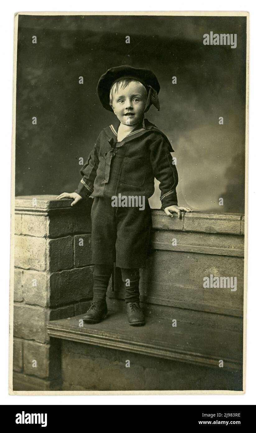 Edwardian studio portrait of happy, cute young boy wearing a sailor suit, dated September 1908 by a boarding house owner from Clacton-on-Sea, Essex, England, U.K. Stock Photo