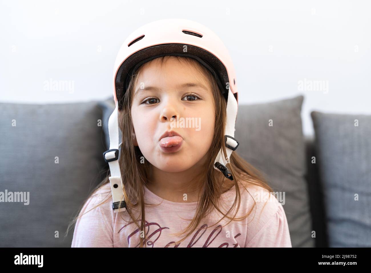 Preschool girl portrait with safety for outdoors activities. Pink
