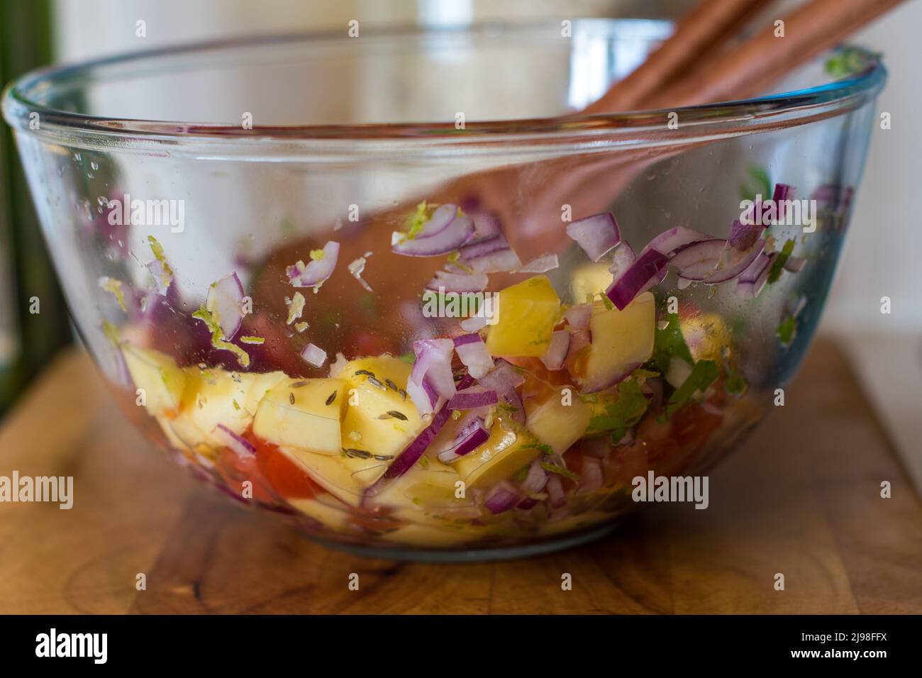 Homemade Mango and tomato Salsa in a bowl on a kitchen counter Stock Photo