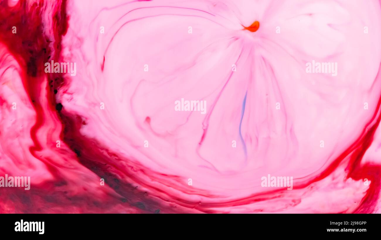 Pink liquid abstract surface. Colorful spots on a water surface. Fluid