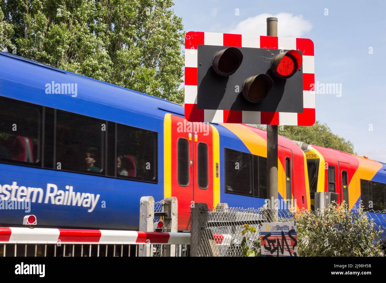 A South Western Railway train passing Vine Road level crossing, Barnes, London, SW13, England, UK Stock Photo