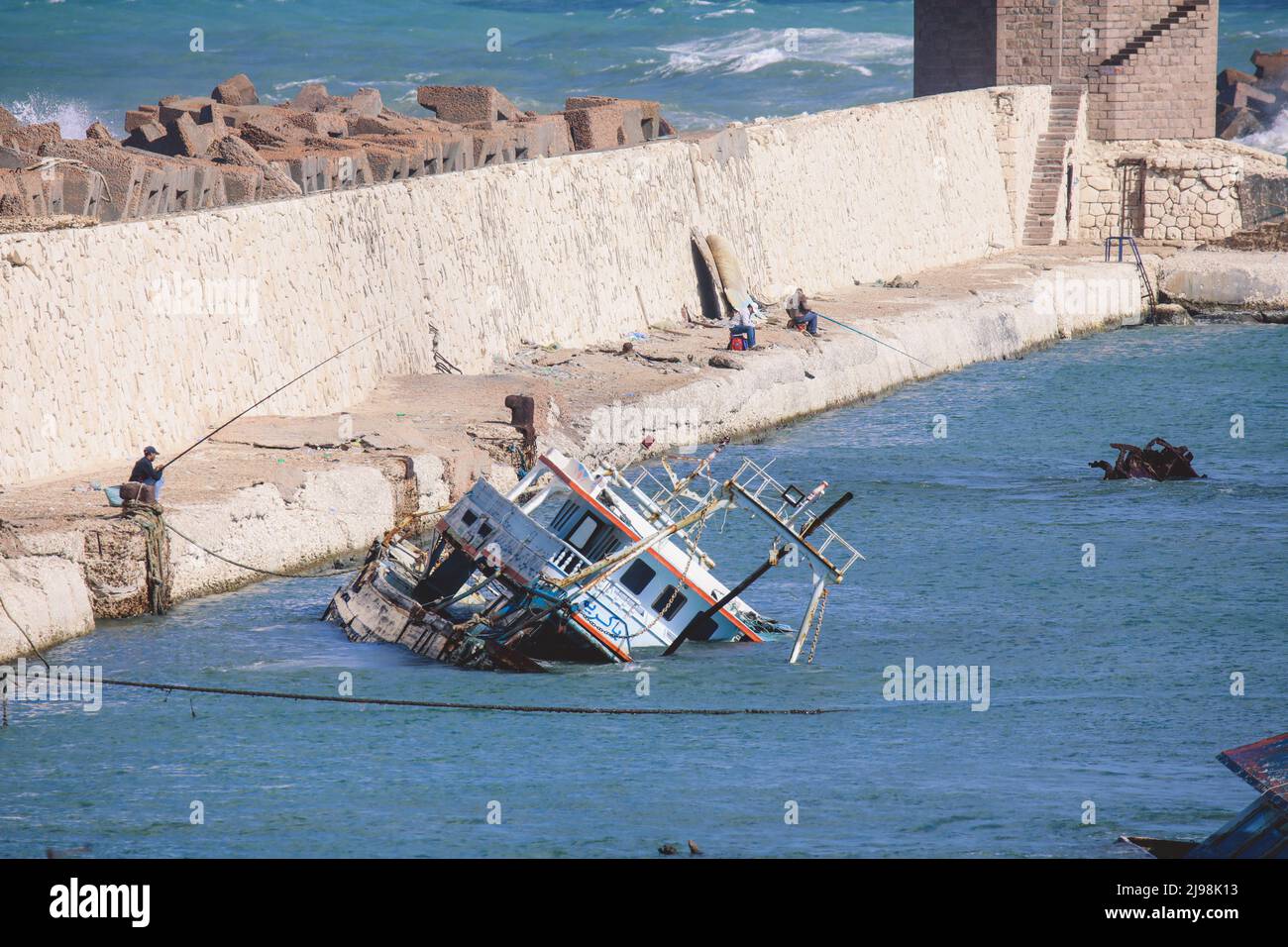 Old Rusted Boats in Blue Water of Alexandria Harbor, Egypt Stock Photo