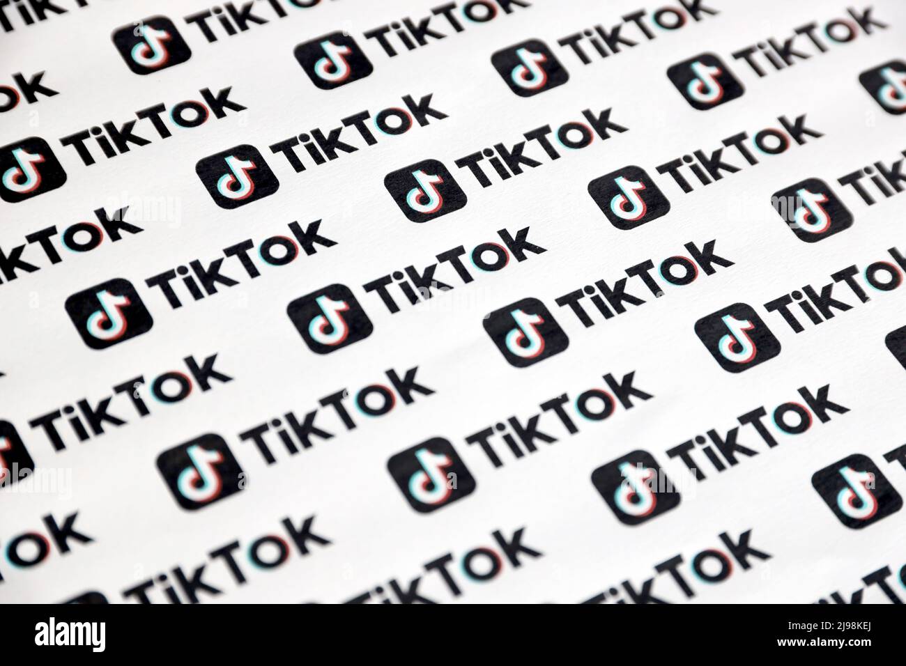 TERNOPIL, UKRAINE - MAY 2, 2022: Many TikTok logo printed on paper. Tiktok or Douyin is a famous Chinese short-form video hosting service owned by Byt Stock Photo