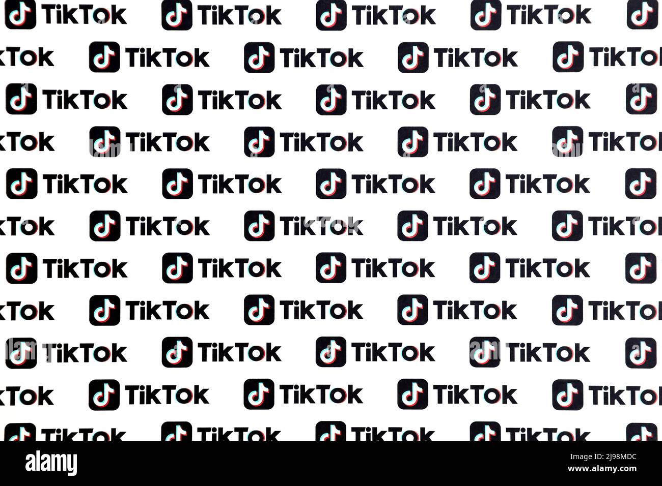 TERNOPIL, UKRAINE - MAY 2, 2022: Many TikTok logo printed on paper. Tiktok or Douyin is a famous Chinese short-form video hosting service owned by Byt Stock Photo