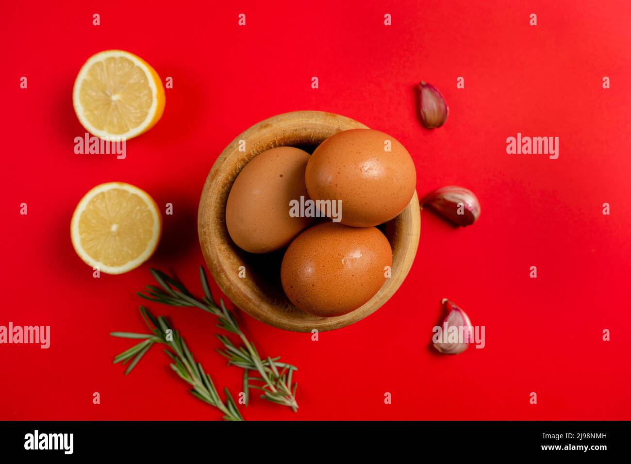 Top view of eggs, lemons and garlic ingredients needed to make the rich homemade alioli sauce typical Spanish sauce Stock Photo