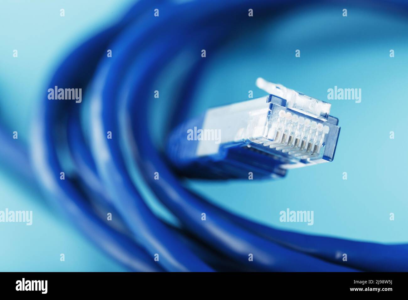 A coil of RJ45 Cat.6 Network Cable isolated on a blue