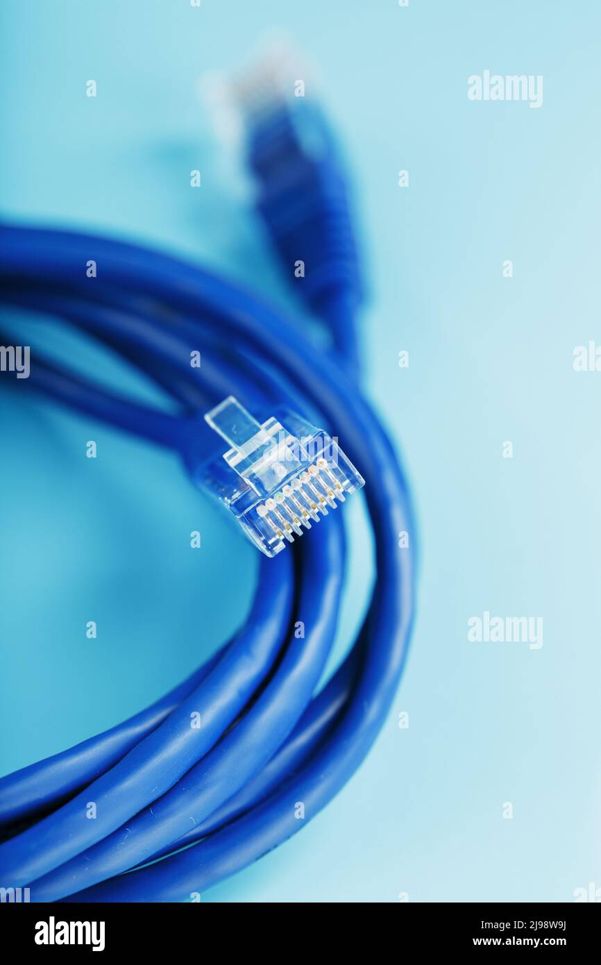 A coil of RJ45 Cat.6 Network Cable isolated on a blue