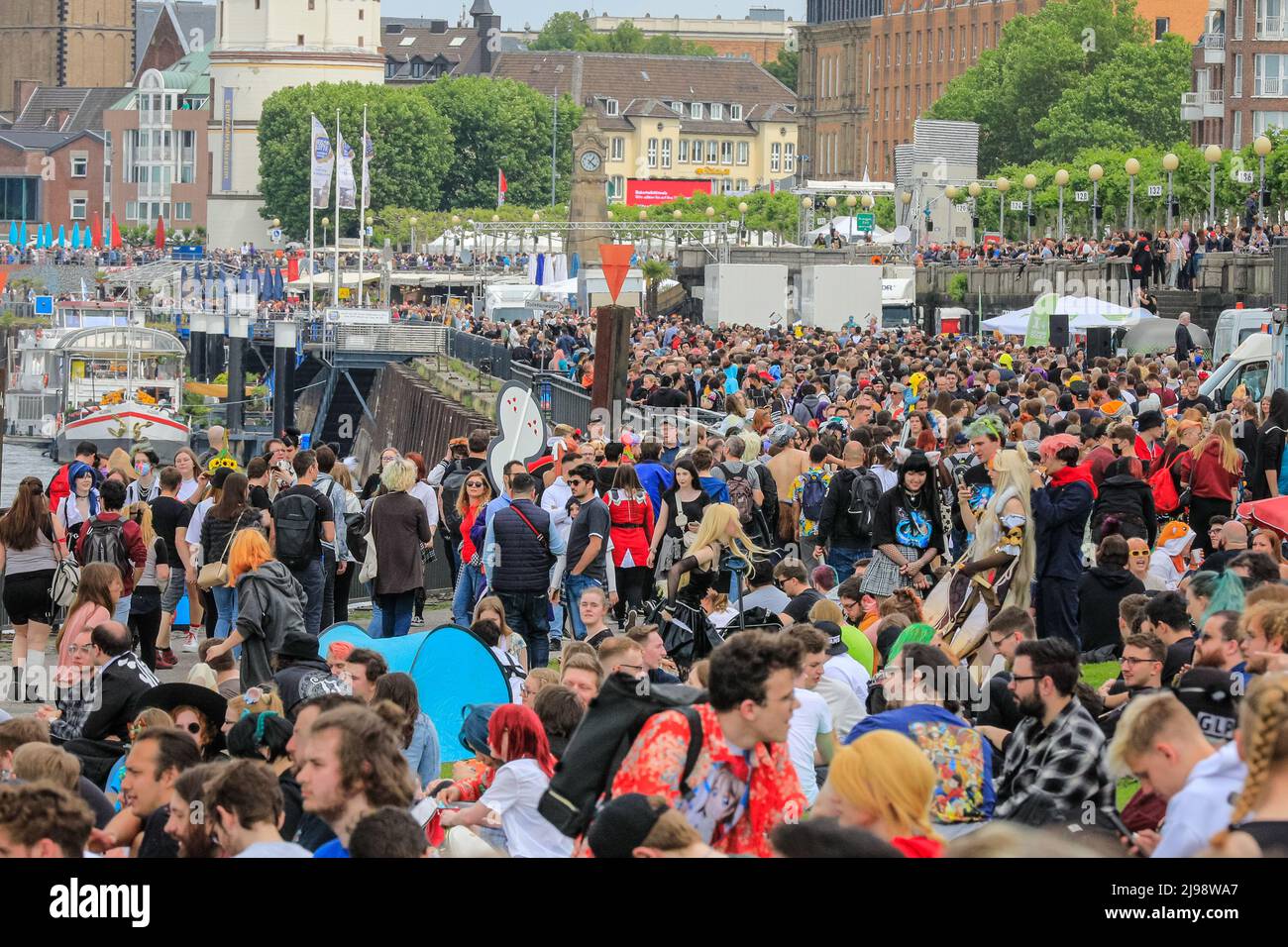Düsseldorf, NRW, Germany. 21st May, 2022. The river bank is packed with people. Tens of thousands of visitors and cosplayers enjoy the warm sunshine along the river Rhine embankment in their outfits inspired by Japanese anime, video and games. Stage performances, cosplay, stalls and demonstrations of Japanese culture, sports and traditions are featured at Düsseldorf's annual Japan Day, celebrating Japan and the Japanese community in the city. Düsseldorf is home to the largest Japanese community in Germany. Credit: Imageplotter/Alamy Live News Stock Photo