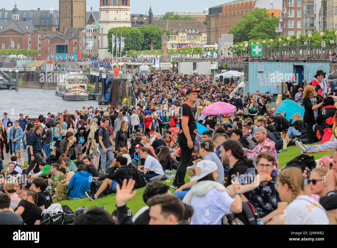 Düsseldorf, NRW, Germany. 21st May, 2022. The river bank is packed with people. Tens of thousands of visitors and cosplayers enjoy the warm sunshine along the river Rhine embankment in their outfits inspired by Japanese anime, video and games. Stage performances, cosplay, stalls and demonstrations of Japanese culture, sports and traditions are featured at Düsseldorf's annual Japan Day, celebrating Japan and the Japanese community in the city. Düsseldorf is home to the largest Japanese community in Germany. Credit: Imageplotter/Alamy Live News Stock Photo