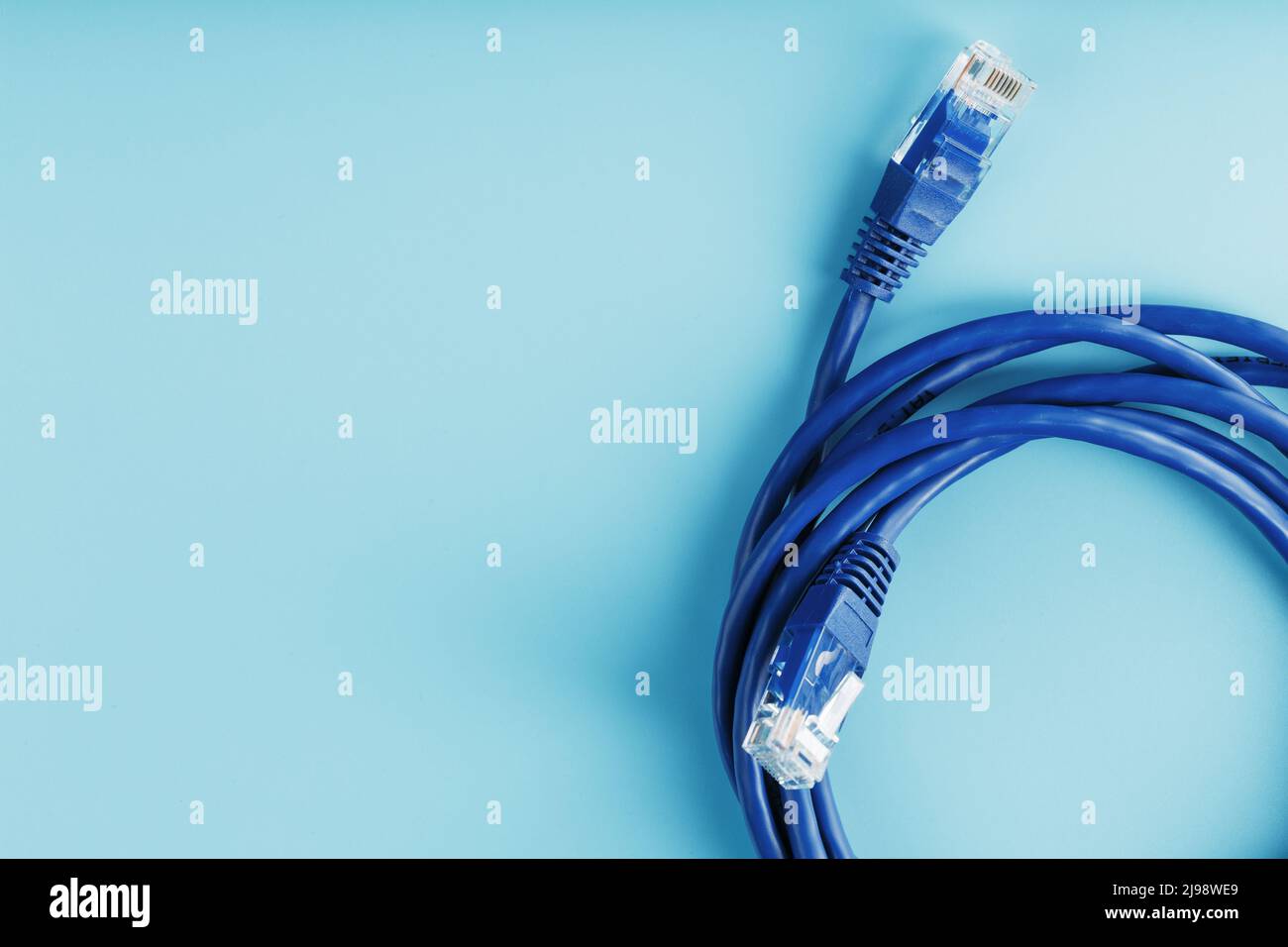 A coil of RJ45 Cat.6 Network Cable isolated on a blue