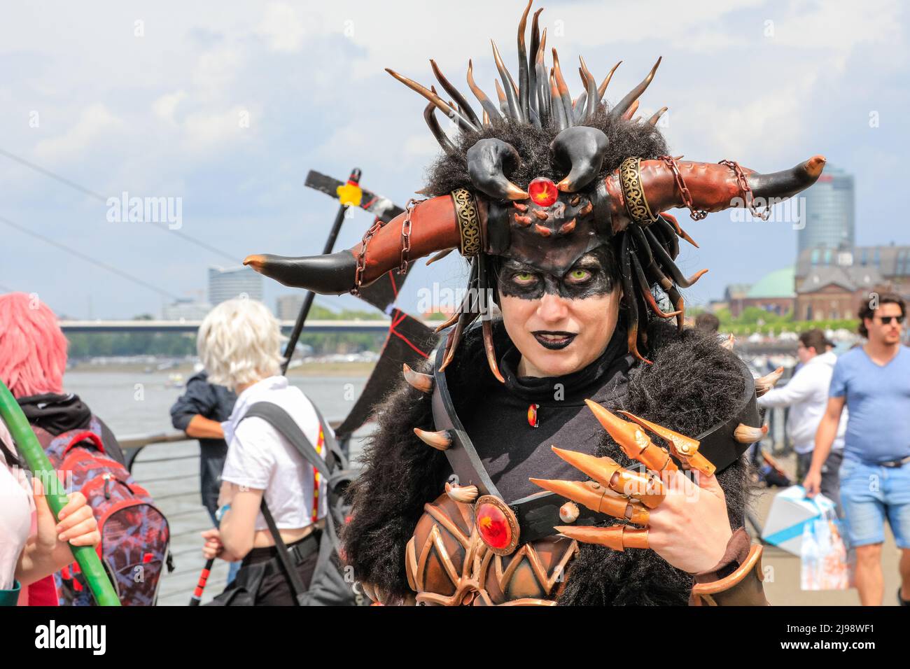 Düsseldorf, NRW, Germany. 21st May, 2022. Cosplayers happily pose for the camera. Tens of thousands of visitors and cosplayers enjoy the warm sunshine along the river Rhine embankment in their outfits inspired by Japanese anime, video and games. Stage performances, cosplay, stalls and demonstrations of Japanese culture, sports and traditions are featured at Düsseldorf's annual Japan Day, celebrating Japan and the Japanese community in the city. Düsseldorf is home to the largest Japanese community in Germany. Credit: Imageplotter/Alamy Live News Stock Photo