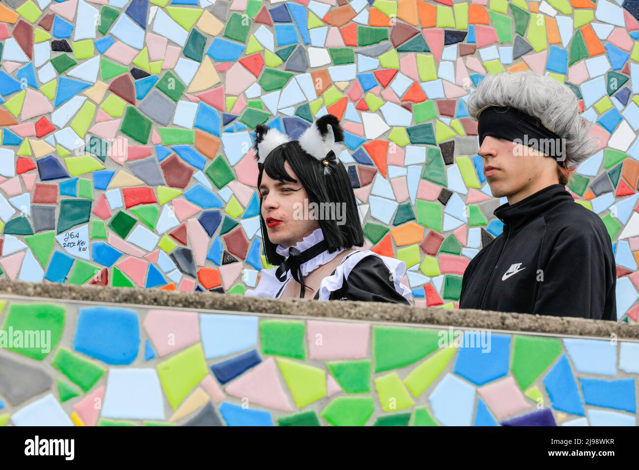 Düsseldorf, NRW, Germany. 21st May, 2022. Cosplayers walk along the mosaic wall on the riverbank. Tens of thousands of visitors and cosplayers enjoy the warm sunshine along the river Rhine embankment in their outfits inspired by Japanese anime, video and games. Stage performances, cosplay, stalls and demonstrations of Japanese culture, sports and traditions are featured at Düsseldorf's annual Japan Day, celebrating Japan and the Japanese community in the city. Düsseldorf is home to the largest Japanese community in Germany. Credit: Imageplotter/Alamy Live News Stock Photo