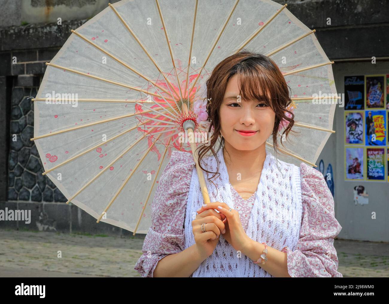 Düsseldorf, NRW, Germany. 21st May, 2022. A young Japanese woman has come in traditional outfit to enjoy the day. Tens of thousands of visitors and cosplayers enjoy the warm sunshine along the river Rhine embankment in their outfits inspired by Japanese anime, video and games. Stage performances, cosplay, stalls and demonstrations of Japanese culture, sports and traditions are featured at Düsseldorf's annual Japan Day, celebrating Japan and the Japanese community in the city. Düsseldorf is home to the largest Japanese community in Germany. Credit: Imageplotter/Alamy Live News Stock Photo